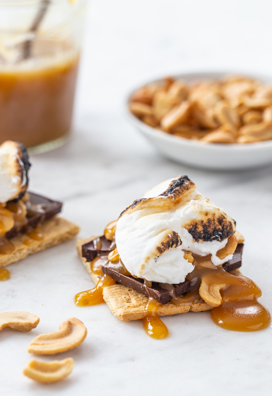 Caramel Cashew S'mores with caramel sauce and cashews in background