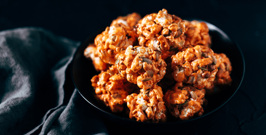 Pumpkin Spice Popcorn Balls in black bowl