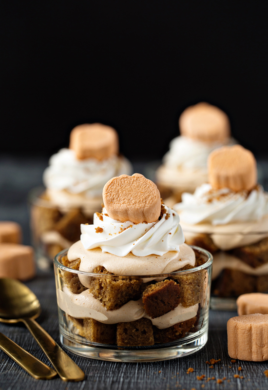 Pumpkin Trifles on dark table with pumpkin marshmallows and spoons